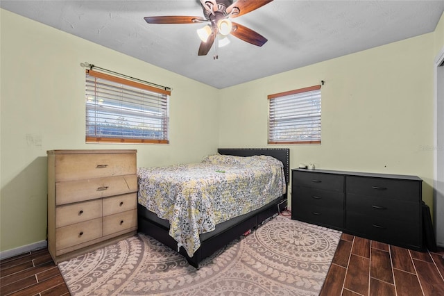 bedroom with a textured ceiling and ceiling fan