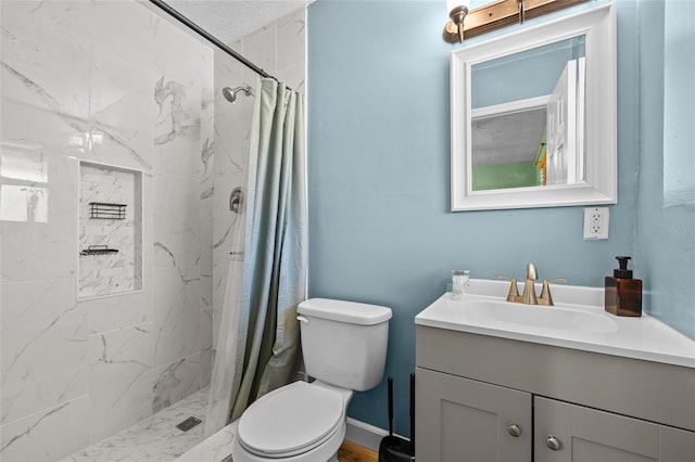 bathroom with vanity, toilet, and curtained shower