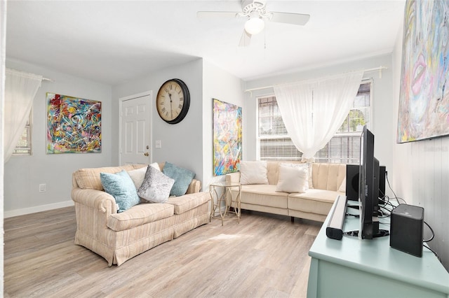 living room featuring hardwood / wood-style floors and ceiling fan