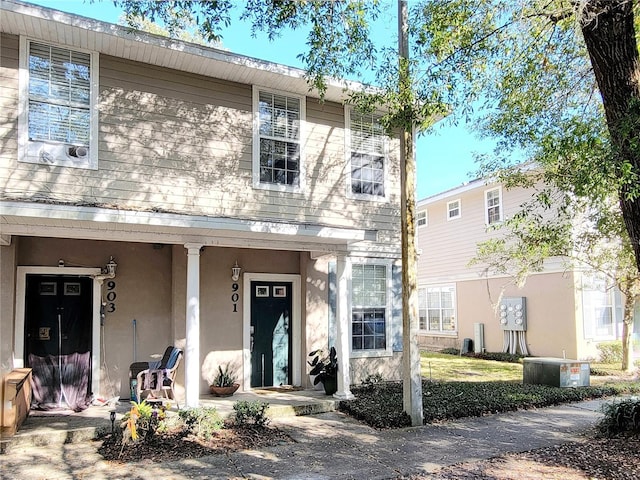 view of front of house featuring cooling unit and covered porch