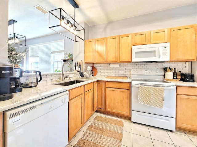 kitchen featuring tasteful backsplash, sink, white appliances, and decorative light fixtures