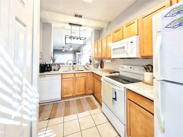 kitchen with light tile patterned flooring, sink, decorative light fixtures, white appliances, and backsplash