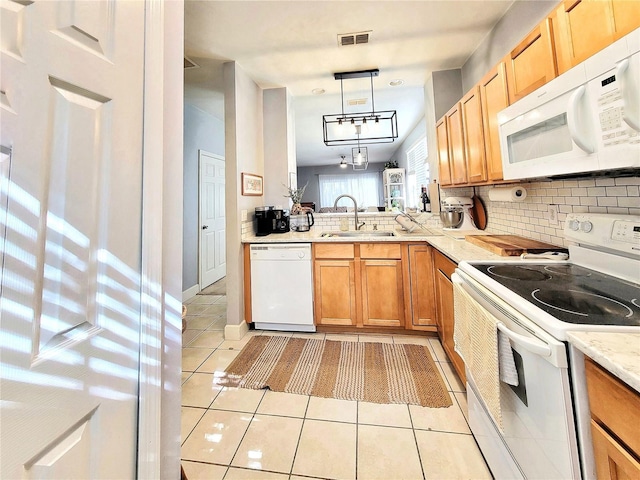 kitchen featuring light tile patterned flooring, tasteful backsplash, sink, hanging light fixtures, and white appliances