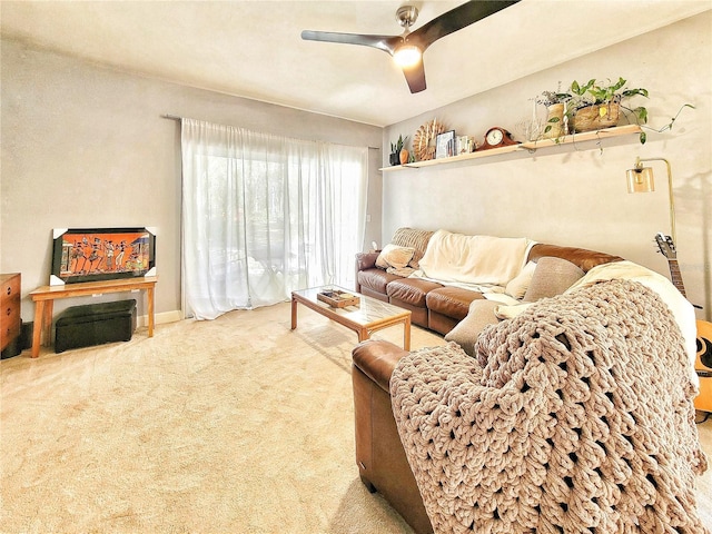 carpeted living room with ceiling fan