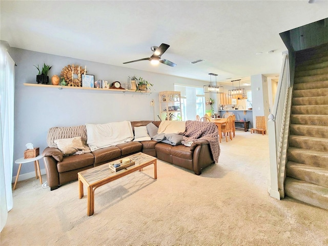 living room featuring light colored carpet and ceiling fan