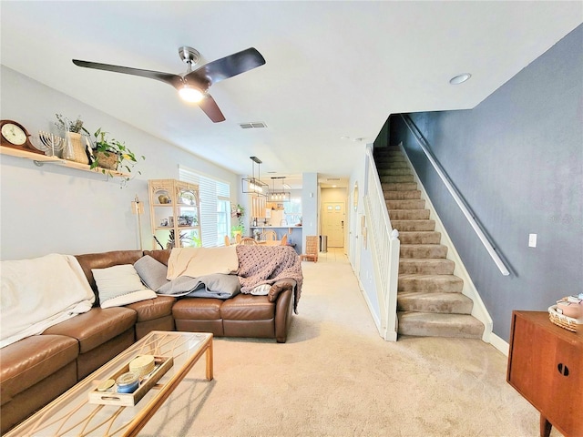 living room featuring light colored carpet and ceiling fan