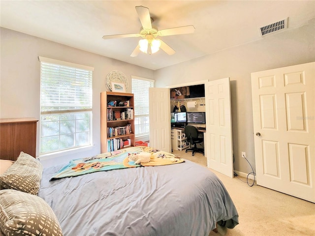 bedroom with light colored carpet, a closet, and ceiling fan