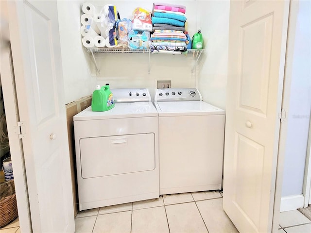 washroom with independent washer and dryer and light tile patterned floors