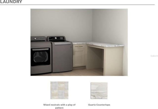 washroom featuring washer and clothes dryer and cabinets