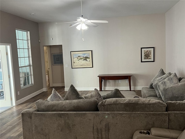 living room featuring wood-type flooring and ceiling fan