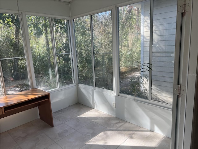 unfurnished sunroom with a wealth of natural light