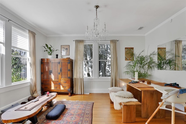 sitting room with an inviting chandelier, crown molding, and light hardwood / wood-style flooring