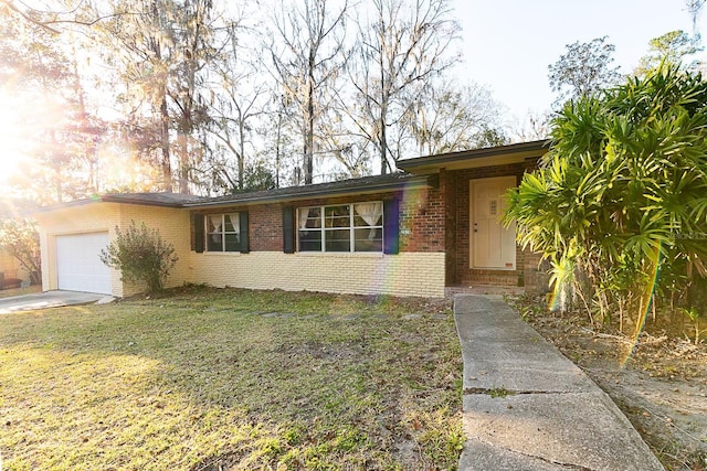 ranch-style home with a garage and a front lawn