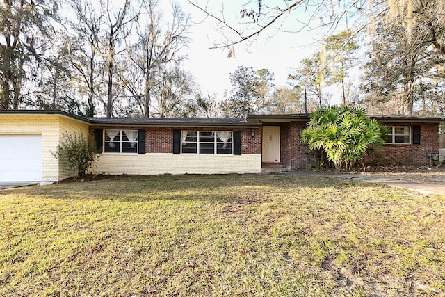 ranch-style home with a garage and a front lawn