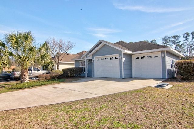 view of front of property with a garage and a front yard