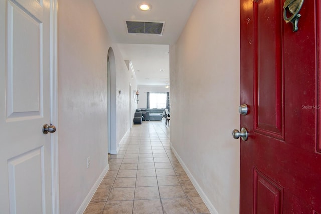 hall with light tile patterned floors