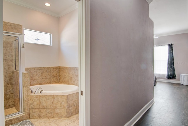 bathroom featuring independent shower and bath, ornamental molding, and hardwood / wood-style flooring