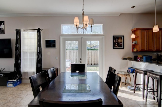 tiled dining room with crown molding, an inviting chandelier, and french doors