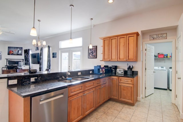 kitchen featuring sink, decorative light fixtures, washer and dryer, dark stone countertops, and dishwasher