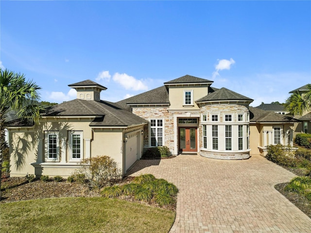 view of front of house with a garage and french doors