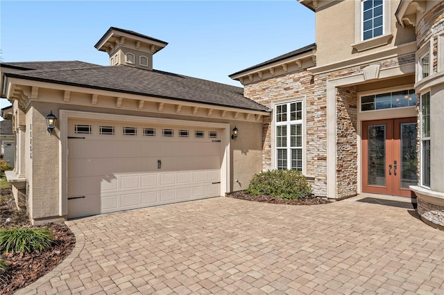 exterior space featuring a garage and french doors