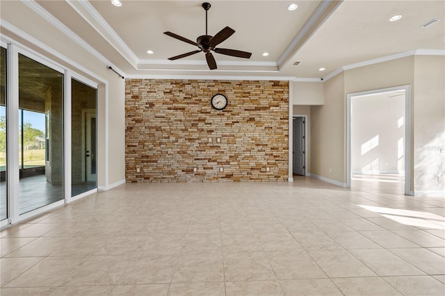 empty room featuring light tile patterned flooring, ceiling fan, ornamental molding, and a raised ceiling