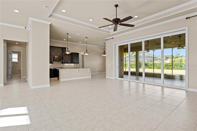 unfurnished living room featuring a tray ceiling, ornamental molding, ceiling fan, and light tile patterned flooring