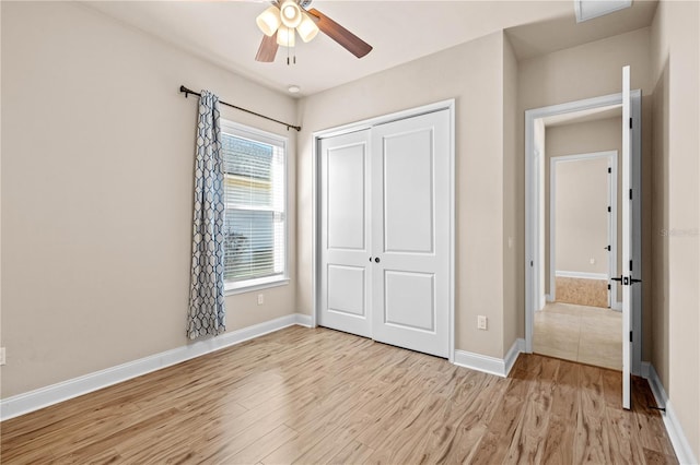 unfurnished bedroom featuring light hardwood / wood-style flooring and a closet