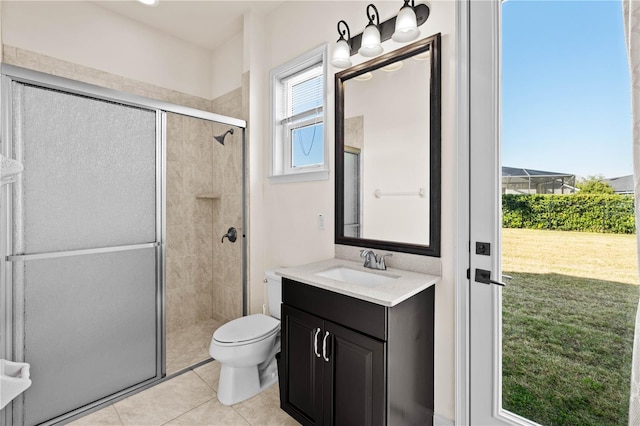 bathroom featuring walk in shower, vanity, tile patterned floors, and toilet