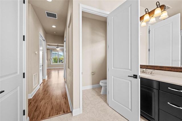 bathroom featuring vanity, tile patterned floors, and toilet