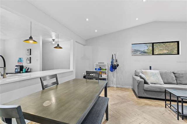 dining space with light parquet floors, vaulted ceiling, and sink