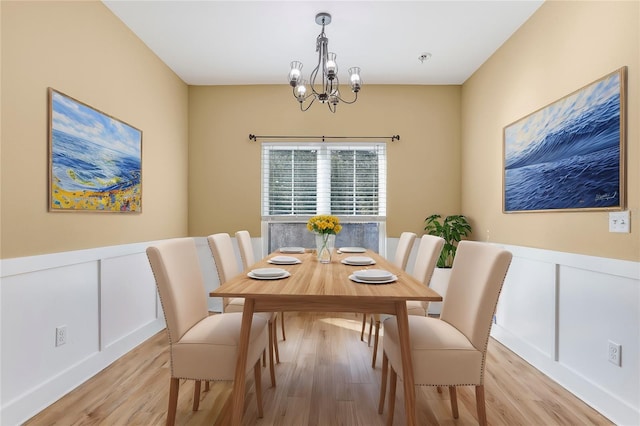 dining area featuring a chandelier and light wood-type flooring