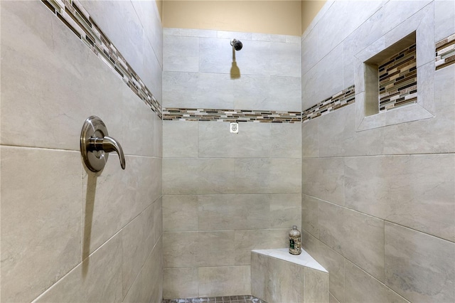 bathroom with a tile shower