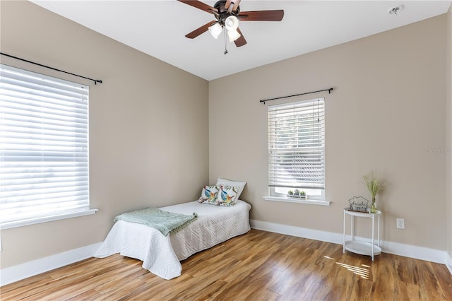 bedroom featuring hardwood / wood-style flooring and ceiling fan