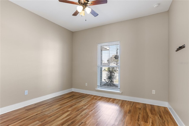 unfurnished room with ceiling fan and hardwood / wood-style floors