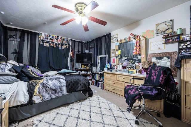 carpeted bedroom with ceiling fan and a textured ceiling