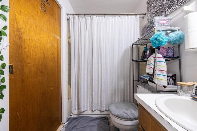 full bathroom with vanity, shower / bath combination with curtain, and toilet