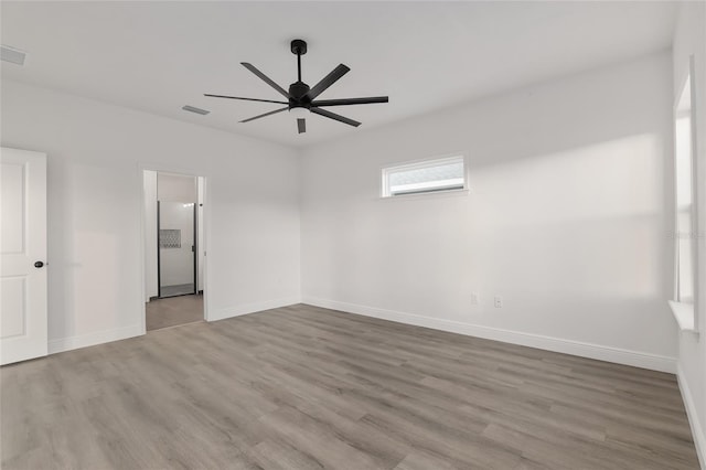 spare room featuring ceiling fan and light wood-type flooring