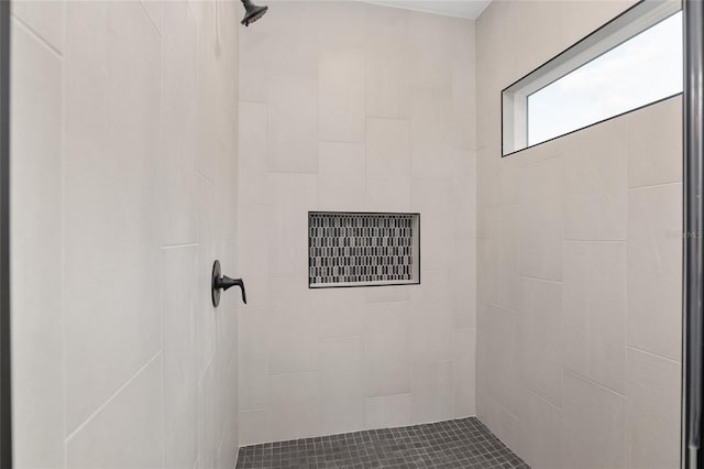 bathroom with tiled shower