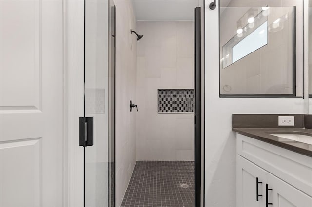 bathroom featuring vanity and a shower with shower door