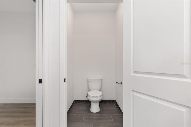 bathroom with toilet and tile patterned flooring