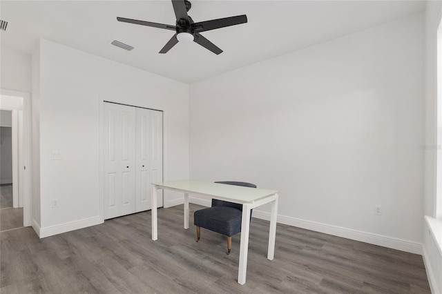 office with dark hardwood / wood-style floors and ceiling fan