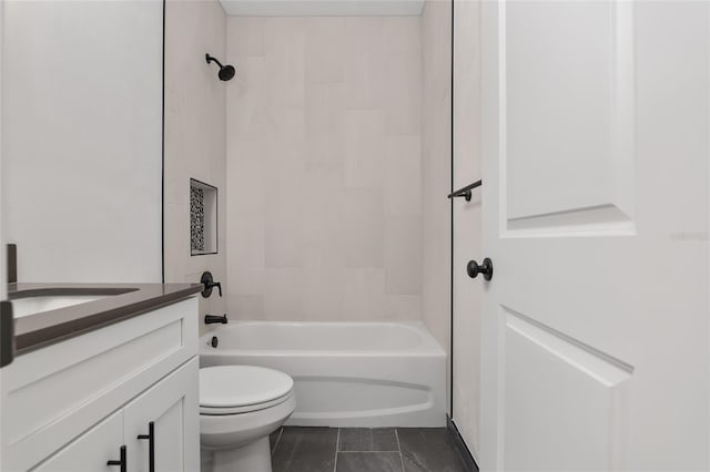 full bathroom with vanity, tiled shower / bath combo, tile patterned floors, and toilet