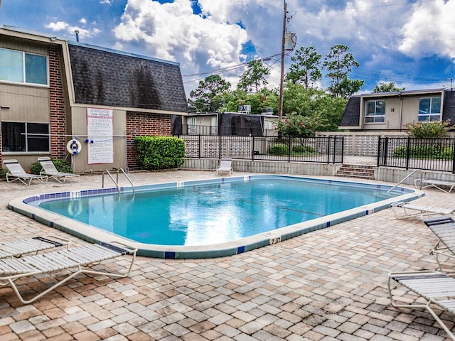 view of swimming pool featuring a patio area