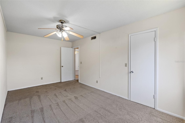 1700 SW 16th Ct Unit J-23, Gainesville, FL 32608 - unfurnished room featuring a ceiling fan, carpet floors, and baseboards