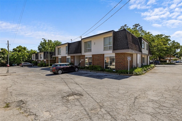 1700 SW 16th Ct Unit J-23, Gainesville, FL 32608 - view of building exterior with uncovered parking