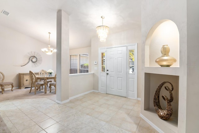 tiled foyer featuring lofted ceiling and a chandelier