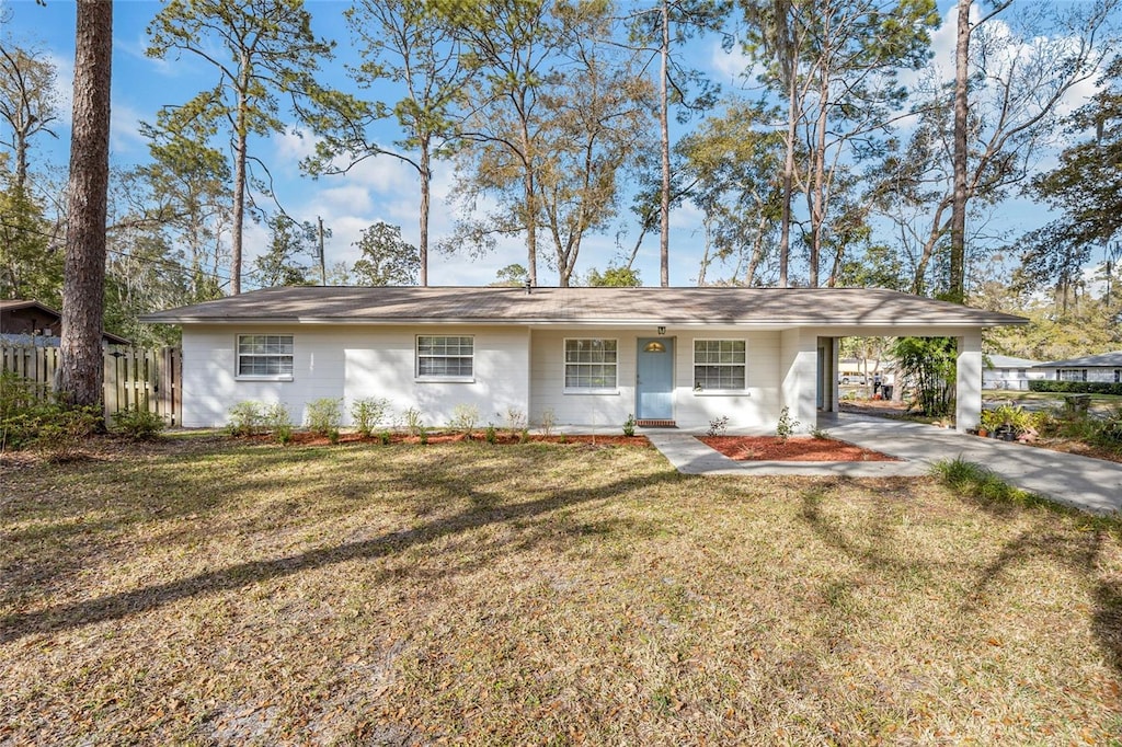 ranch-style house with a carport and a front yard