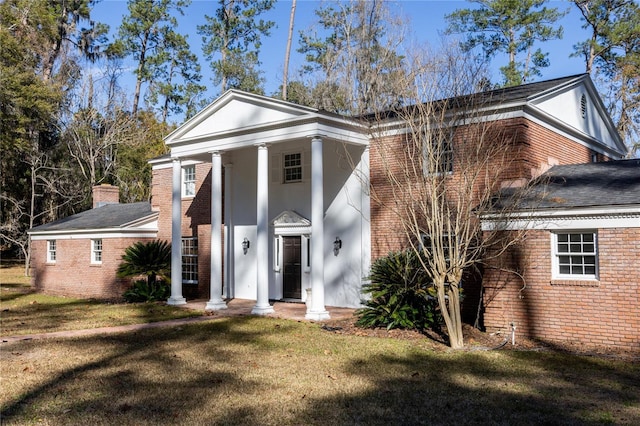 greek revival house featuring a front lawn