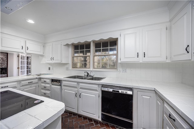 kitchen with sink, tile countertops, white cabinets, and dishwasher